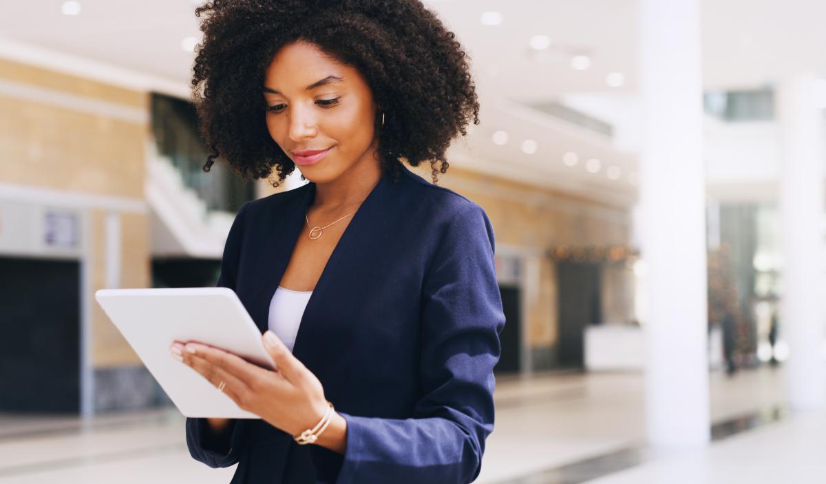 A woman conveniently reading an email on her tablet.